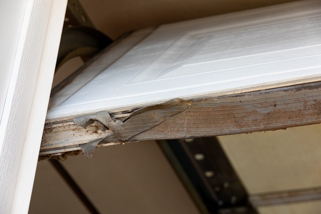 Worn rubber bottom seal on a garage door, weather seal replacement Cumberland Ottawa